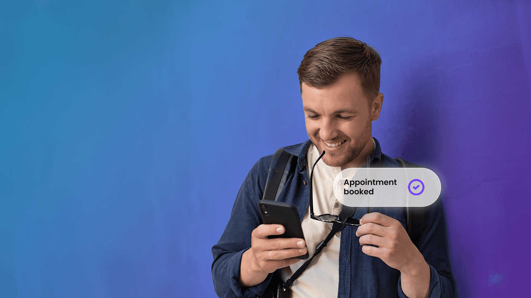 A man is holding a smartphone displaying a successfully created appointment
